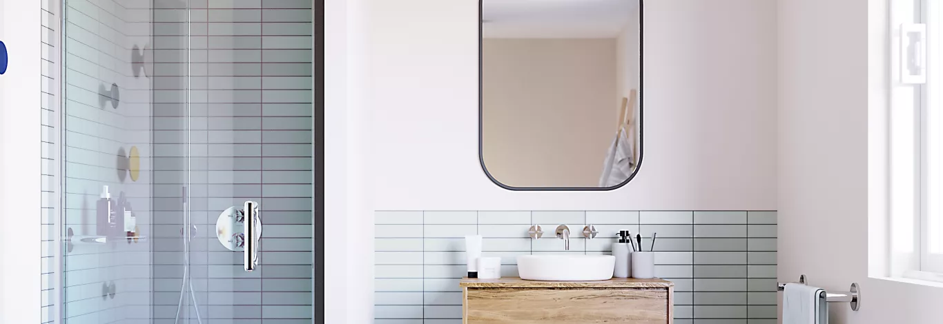 A panoramic image showing the ILI shower on the left and a bathroom sink and mirror on the right.