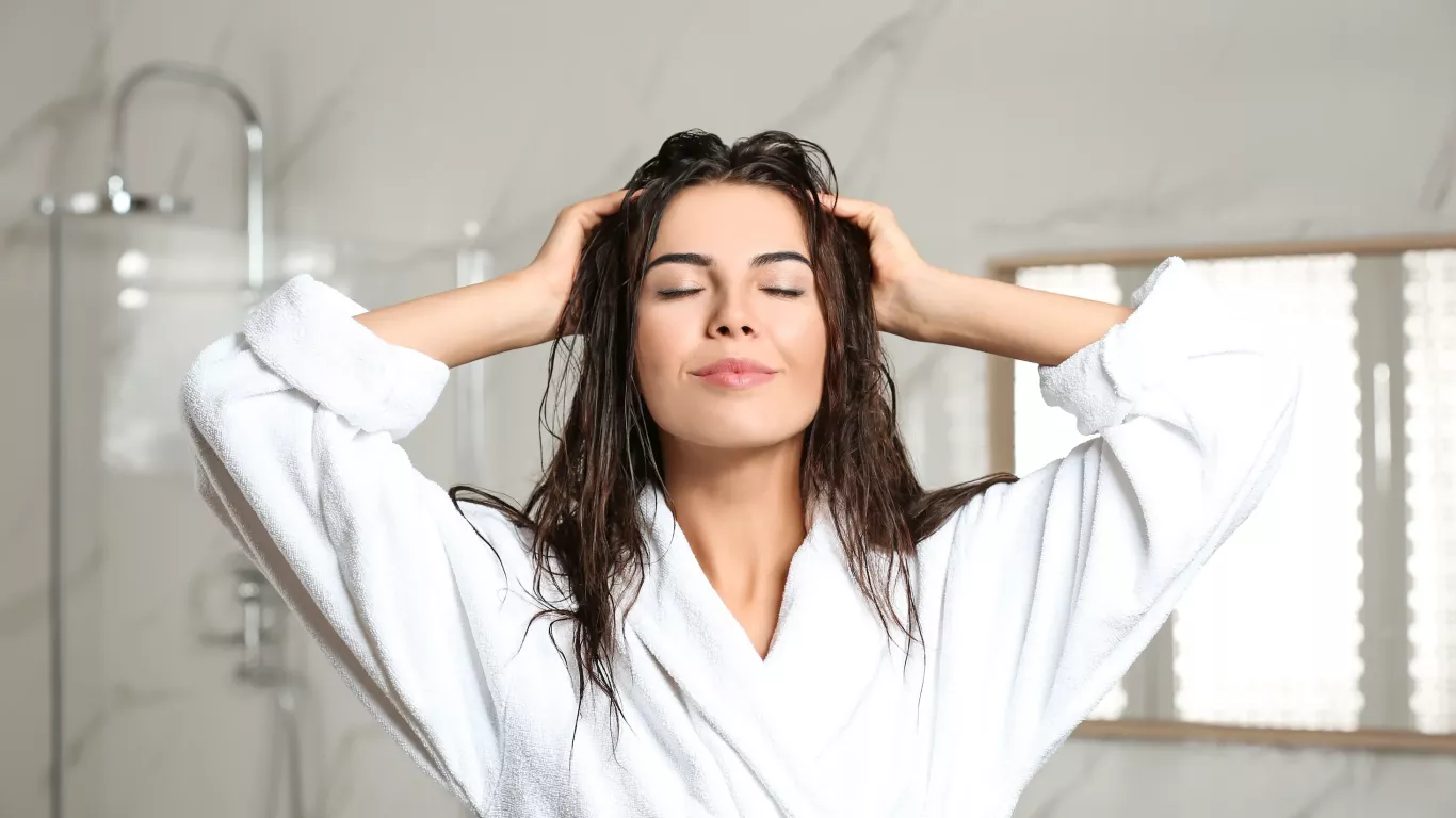 Woman Massages Her Head After Shower