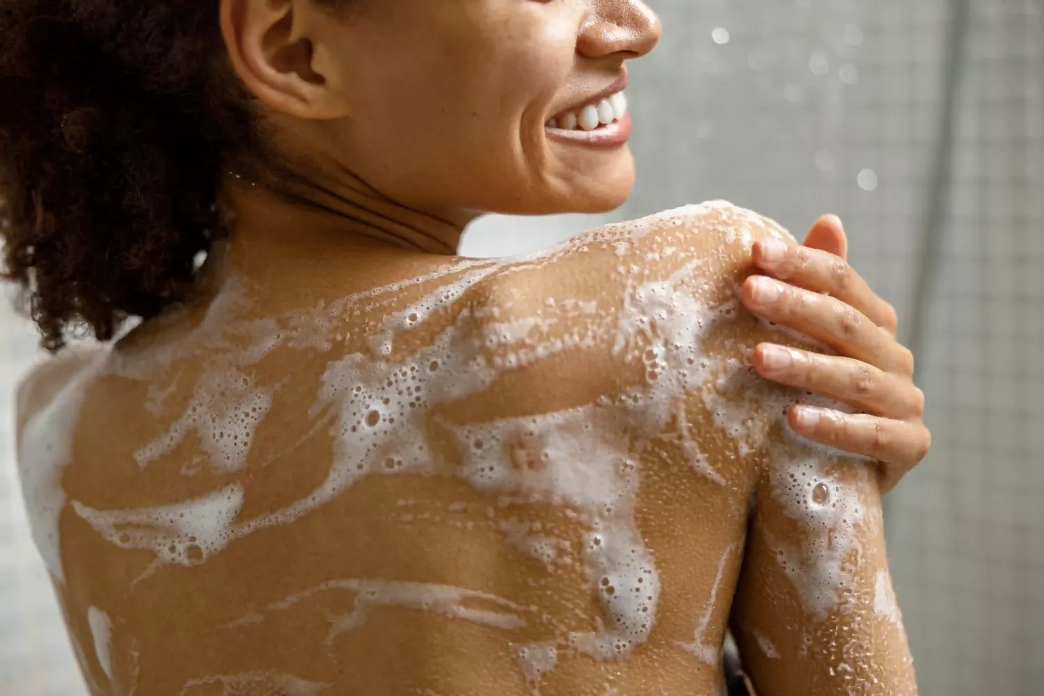 Woman With Suds On Her Back In The Shower R